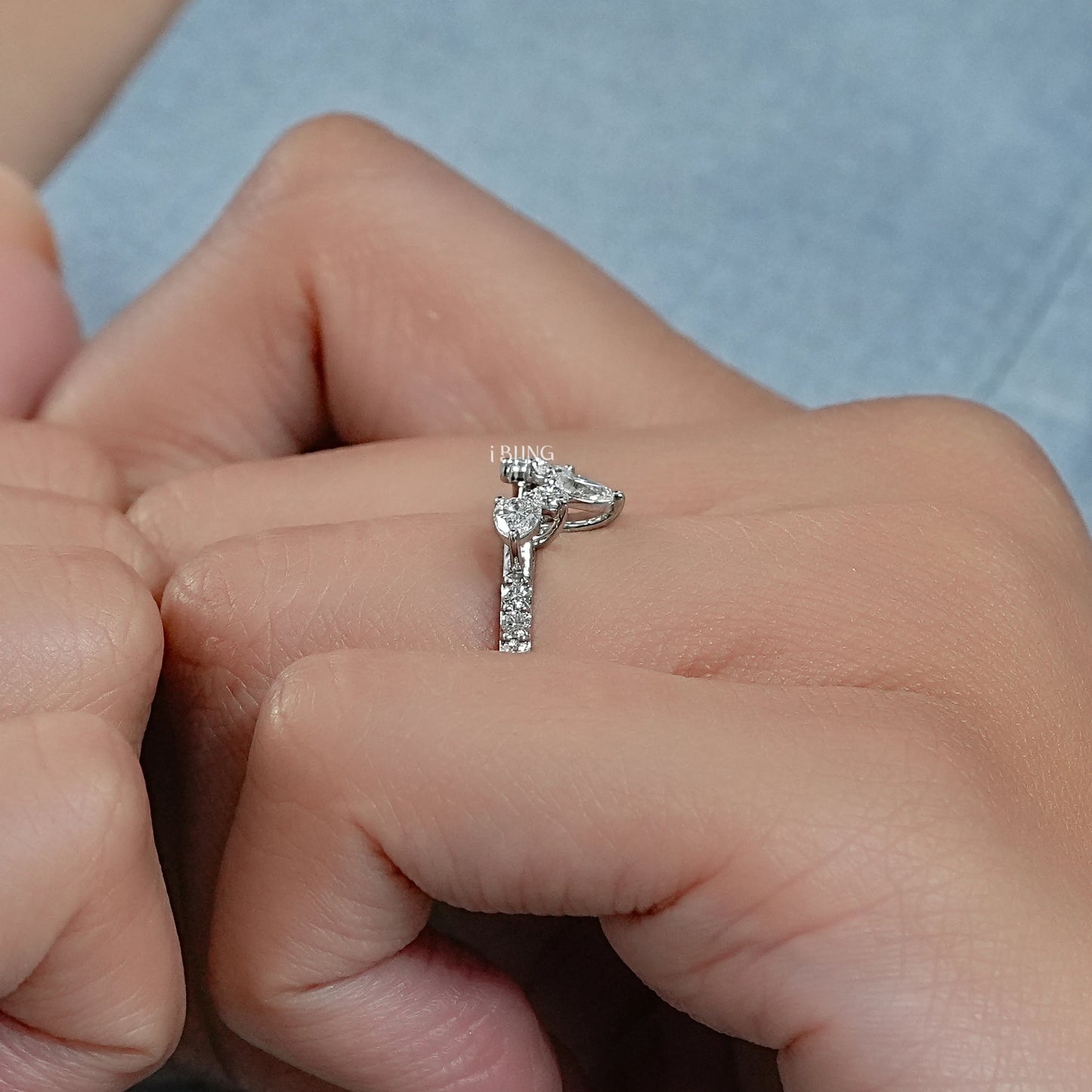 14k white gold chevron wedding ring on hand display low profile setting.