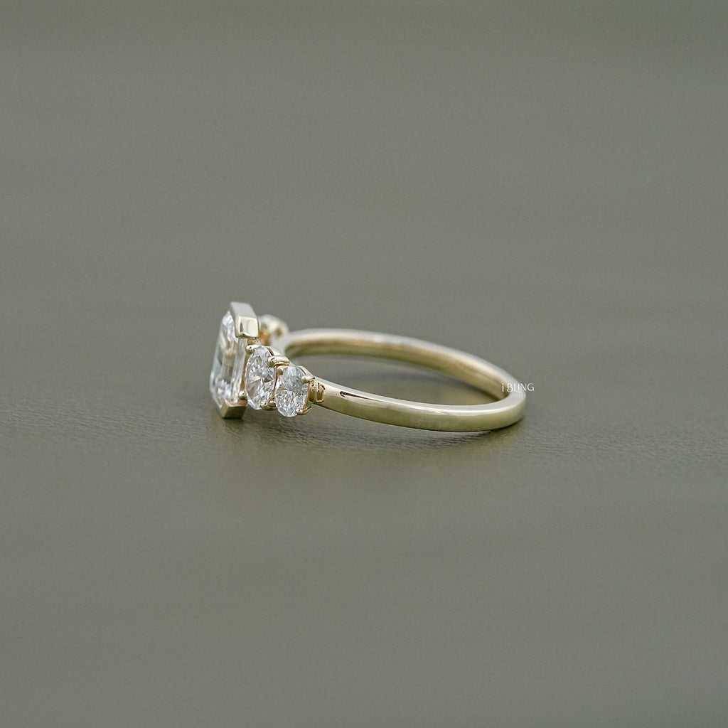 Half Bezel Set Emerald And Oval Five Stone Engagement Ring