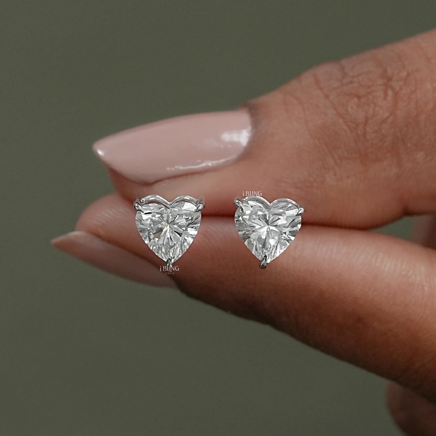 Front view diamond heart earrings styled in classic stud design