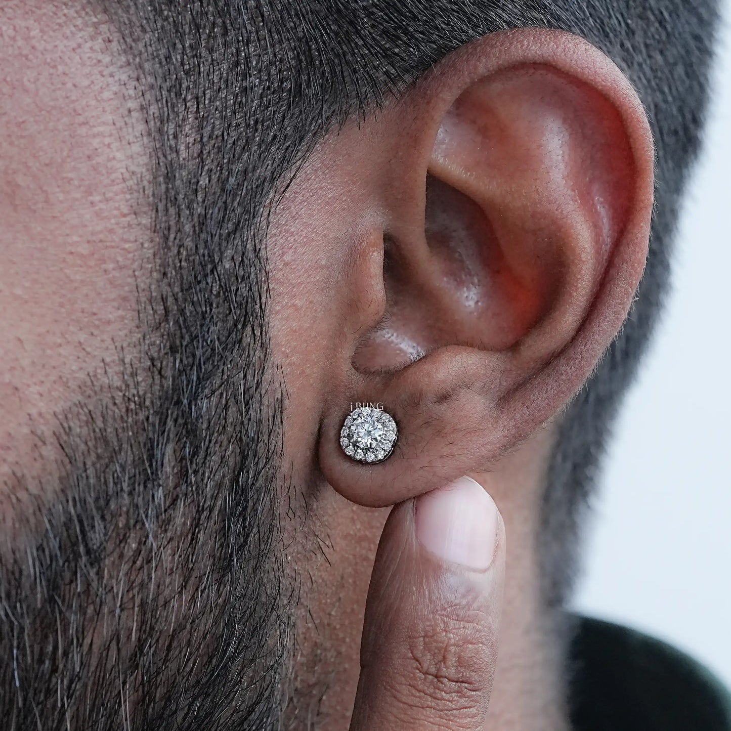 Wearing view stud men's diamond earrings featuring round halo lab diamonds