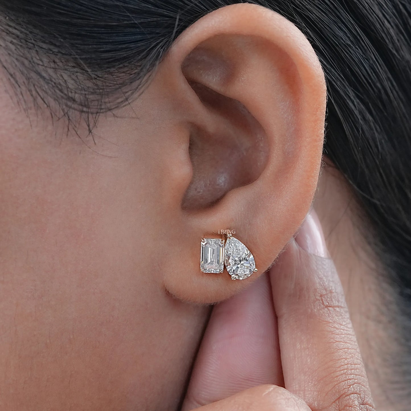 Ear view of pear and emerald toi et moi stud earring for women