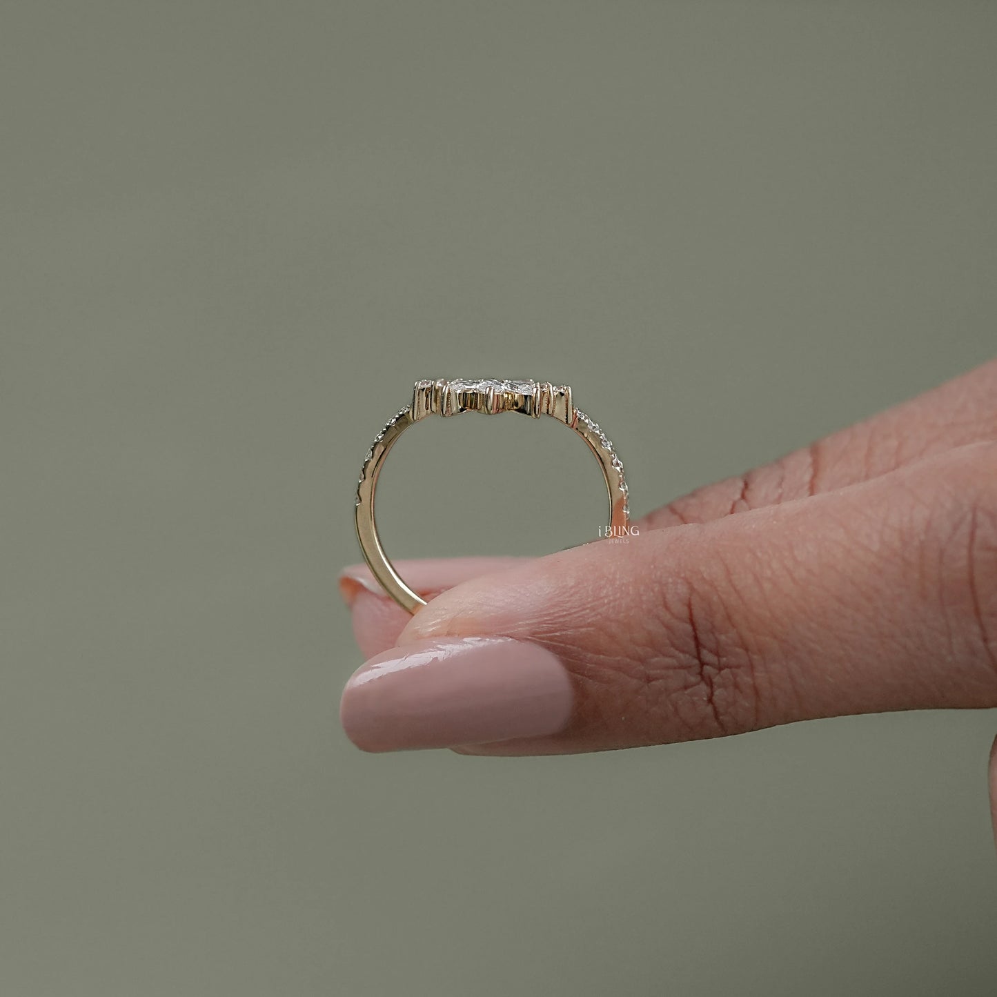 Top view silver curved wedding band featuring marquise and round diamonds