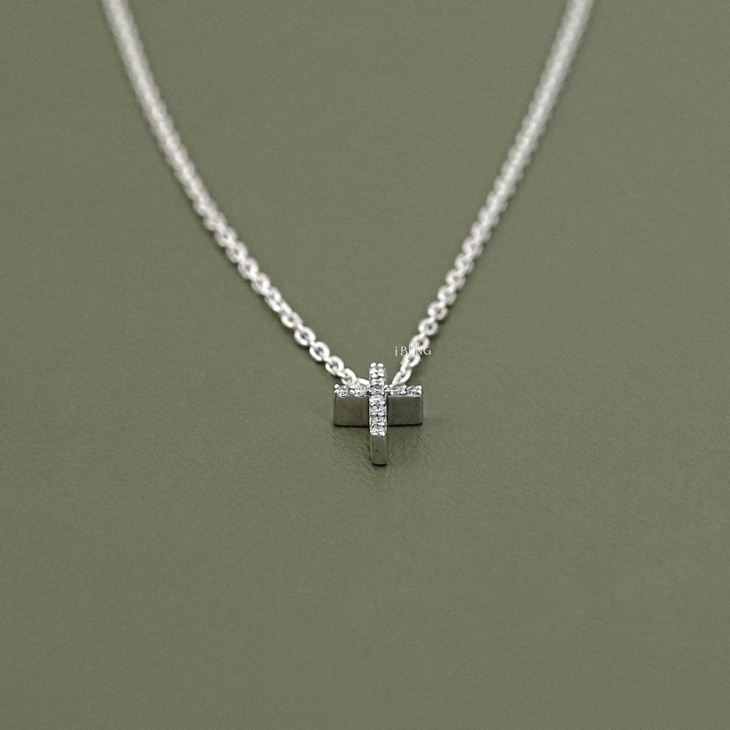 Top view silver diamond cross pendant crafted in clean round diamond layout