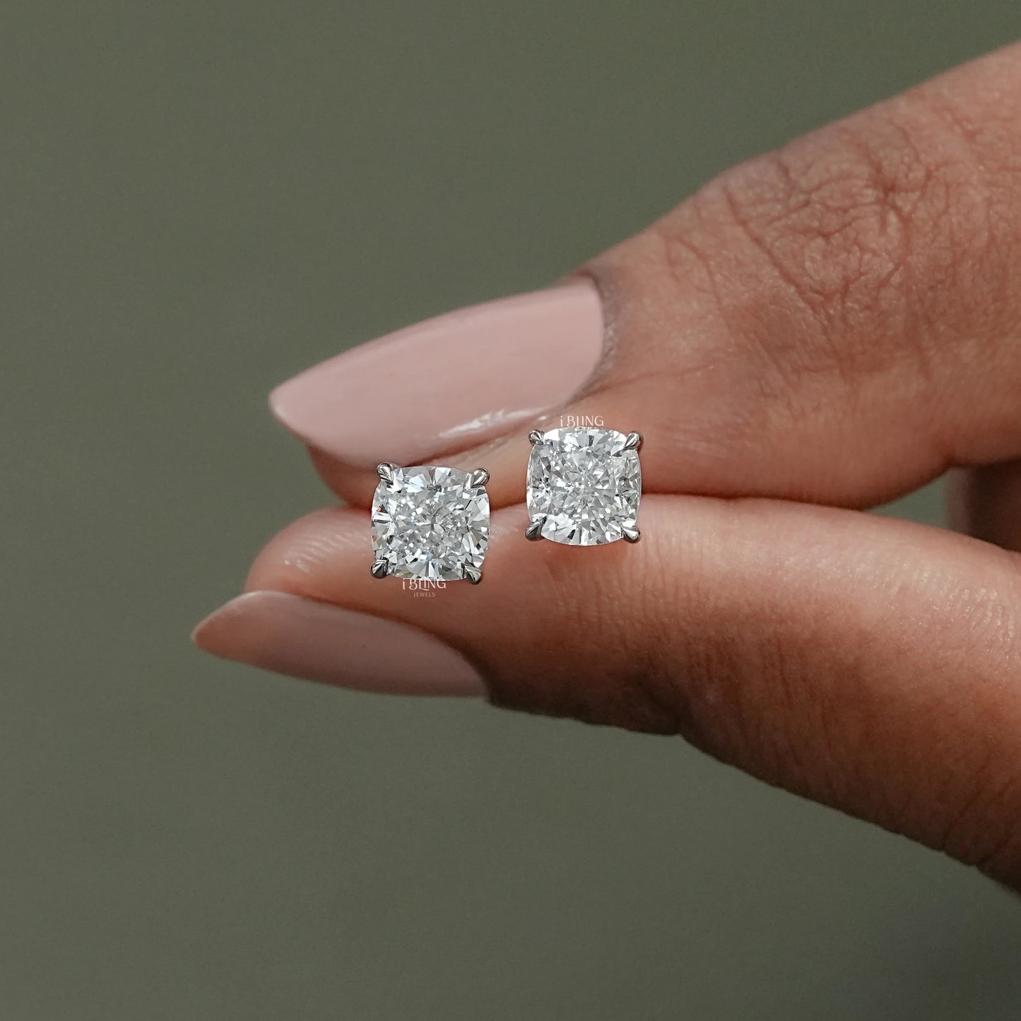 Hand hold view of a beautiful gift for mom, small and stylish studs for everyday wear.