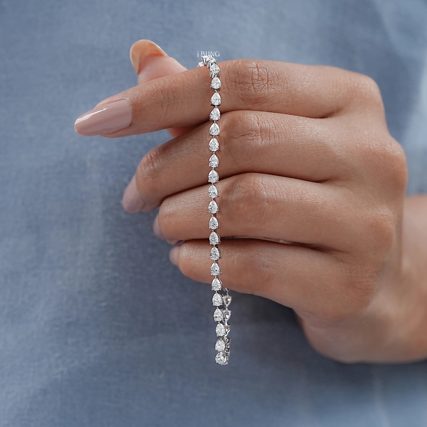 Hand hold women's diamond bracelet showing craftsmanship of link chain