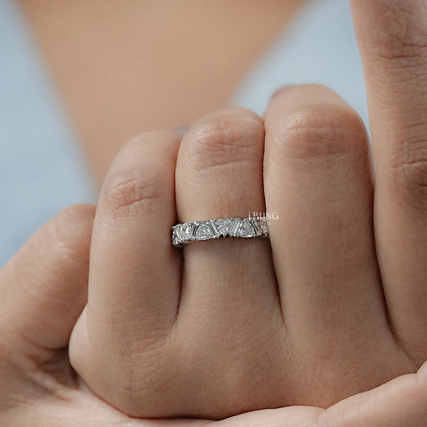 Woman hand Baguette Diamond Band styled in eternity ring design