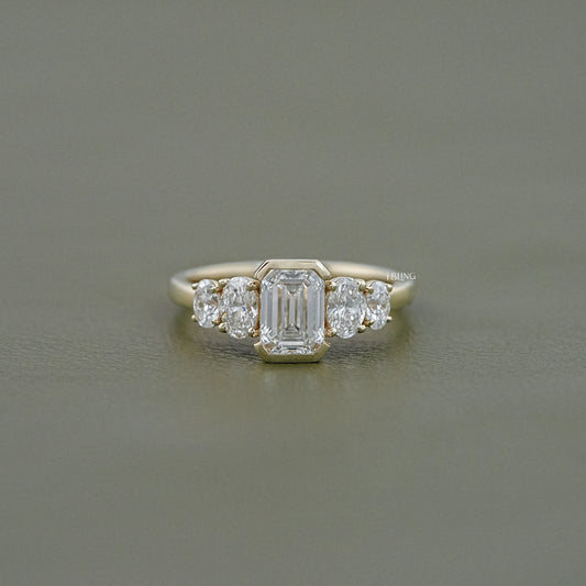 iBling Jewels Oval Half Bezel Set Lab Grown Diamond Engagement Ring featuring Emerald stones