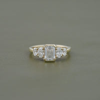 Half Bezel Set Emerald And Oval Five Stone Engagement Ring