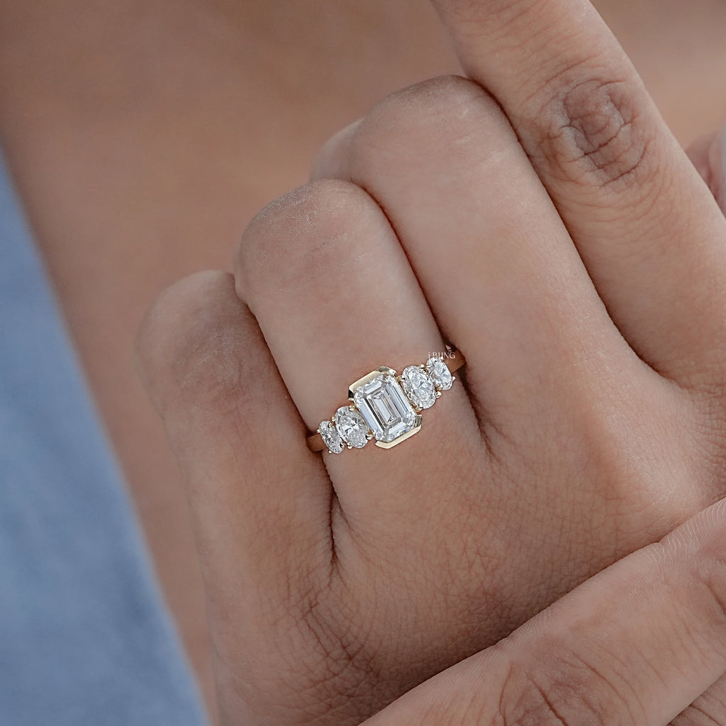 Half Bezel Set Emerald And Oval Five Stone Engagement Ring