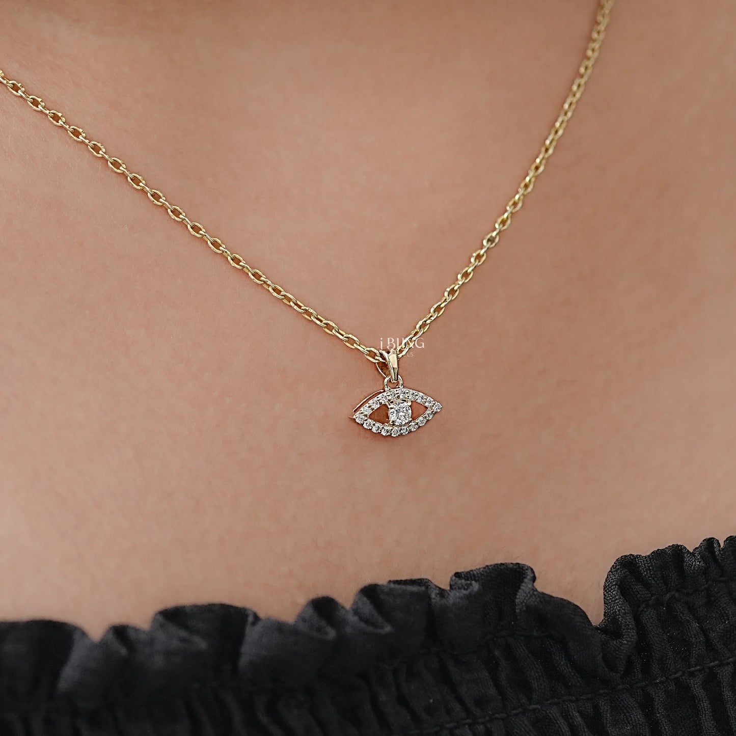 Top view round cut diamond pendant necklace styled in evil eye design