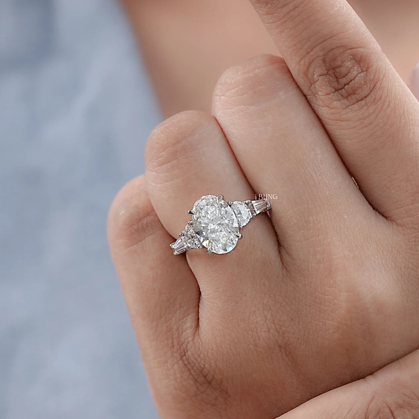 Model hand displaying Oval Half Moon Diamond Five Stone Ring, ideal for engagement and wedding day