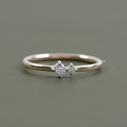 Dainty rings engagement by iBling Jewels with a round diamond and shared prong band.