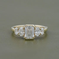Half Bezel Set Emerald And Oval Five Stone Engagement Ring