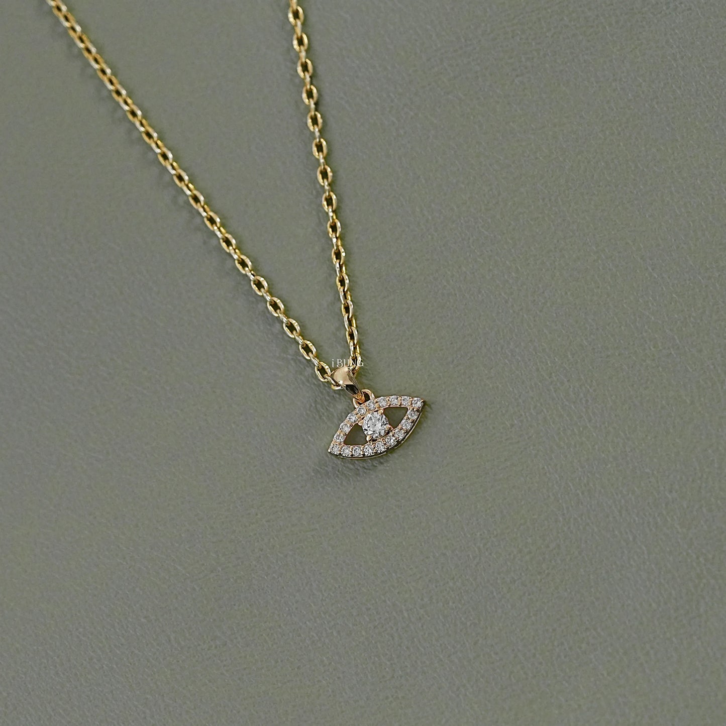 Side view evil eye pendant necklace featuring round lab diamond accent