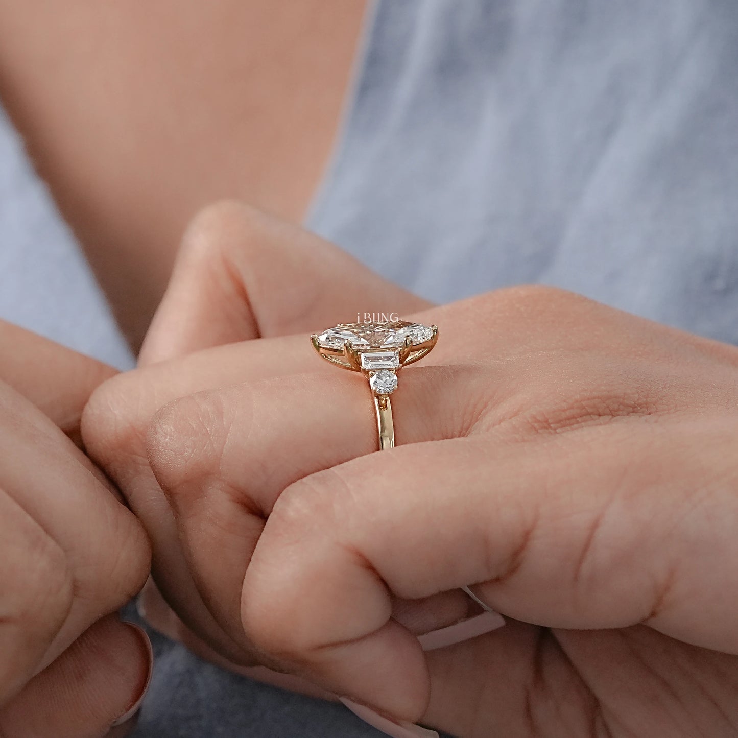 Model hand displays 5 stone engagement Ring with baguette accent for anniversary