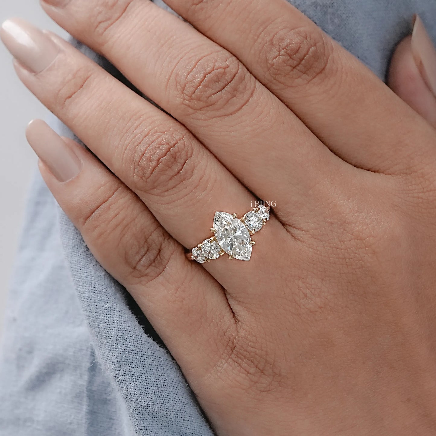 Model hand displays Round and Marquise Lab Grown Diamond Engagement Ring, great for proposal surprise