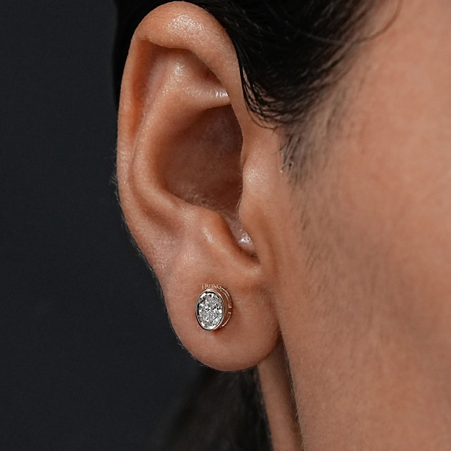 Ear view showing Oval Lab Grown Diamond Bezel Set Stud Earrings, crafted for daily wear and gifting