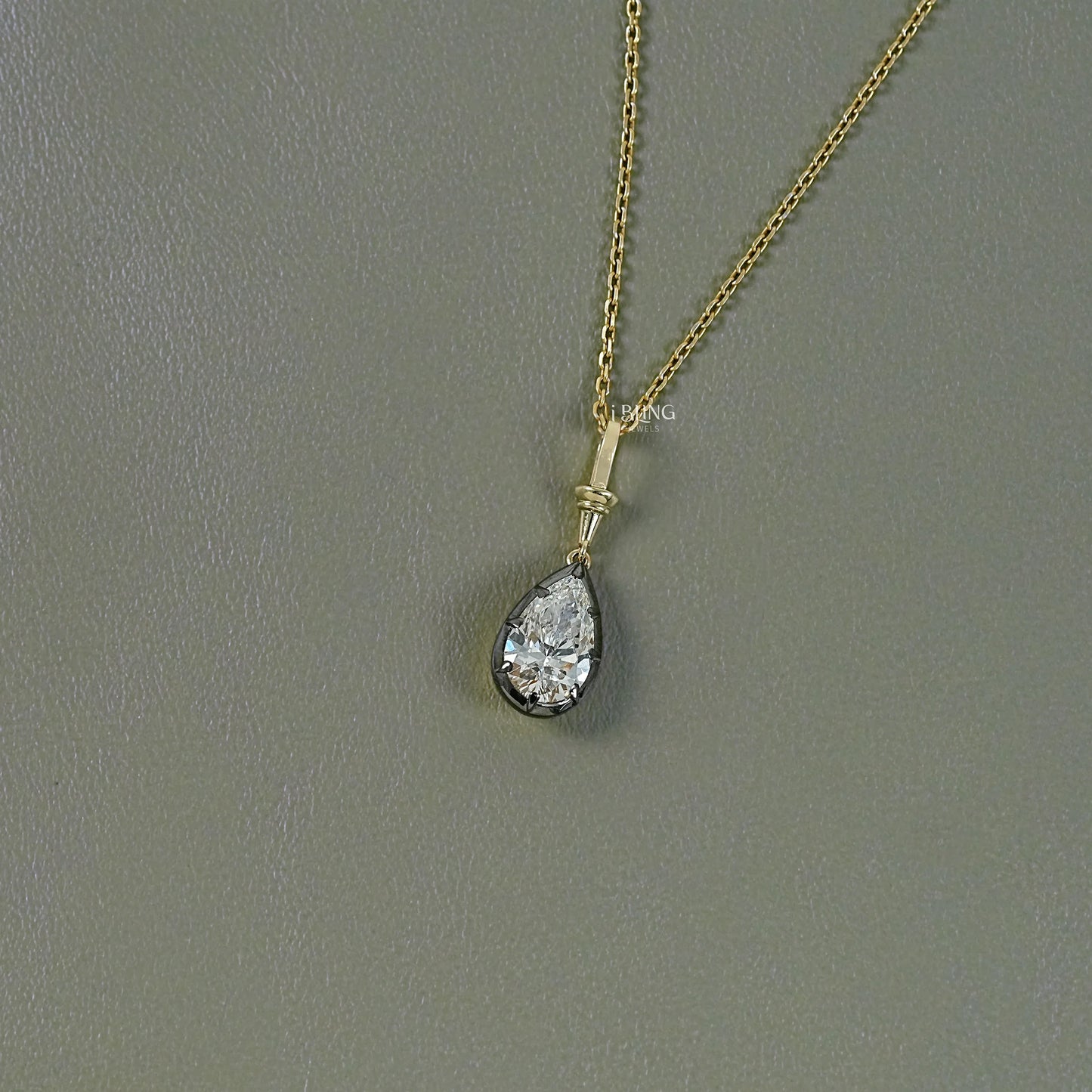 Front view pear cut diamond pendant crafted in clean solitaire style