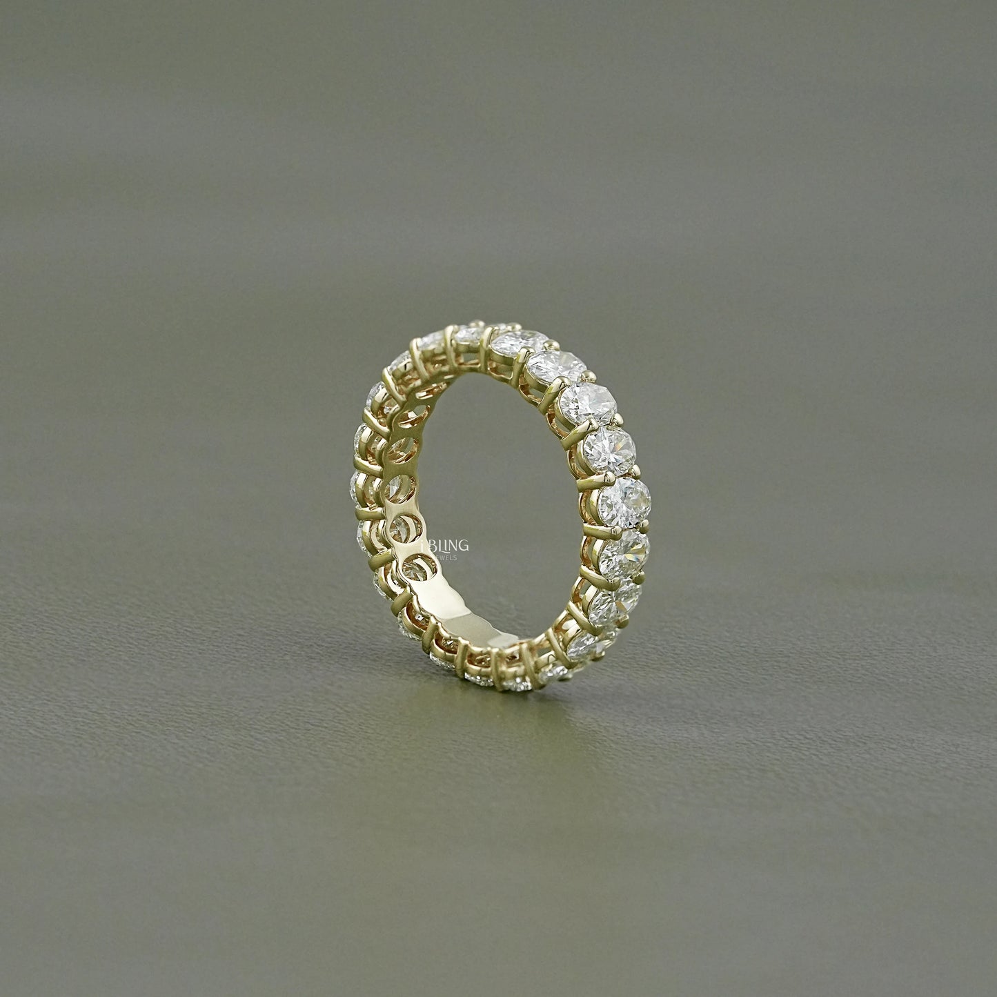 Side view oval diamond wedding band crafted in continuous eternity style