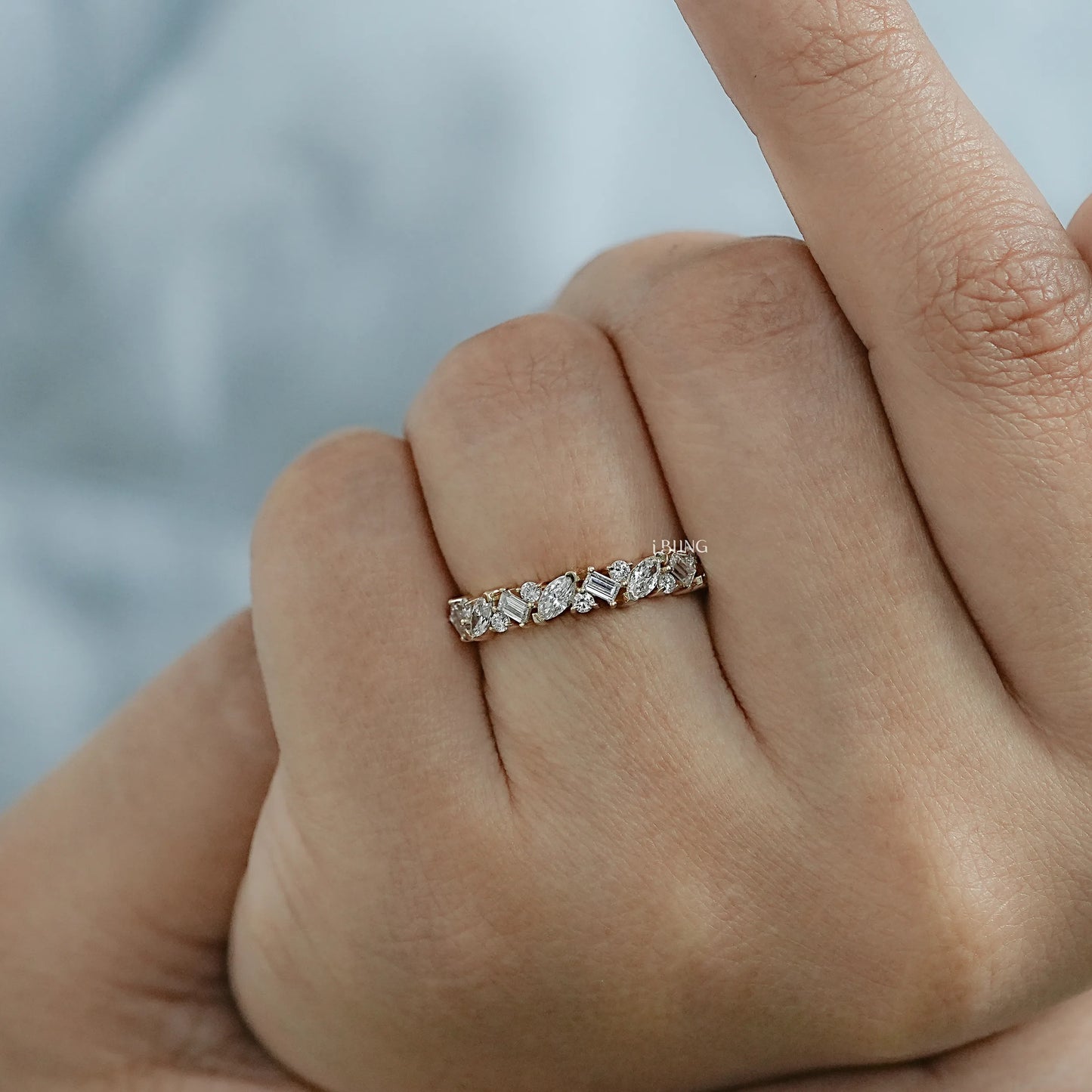 Woman wearing diamond half eternity band designed with multi shape diamonds