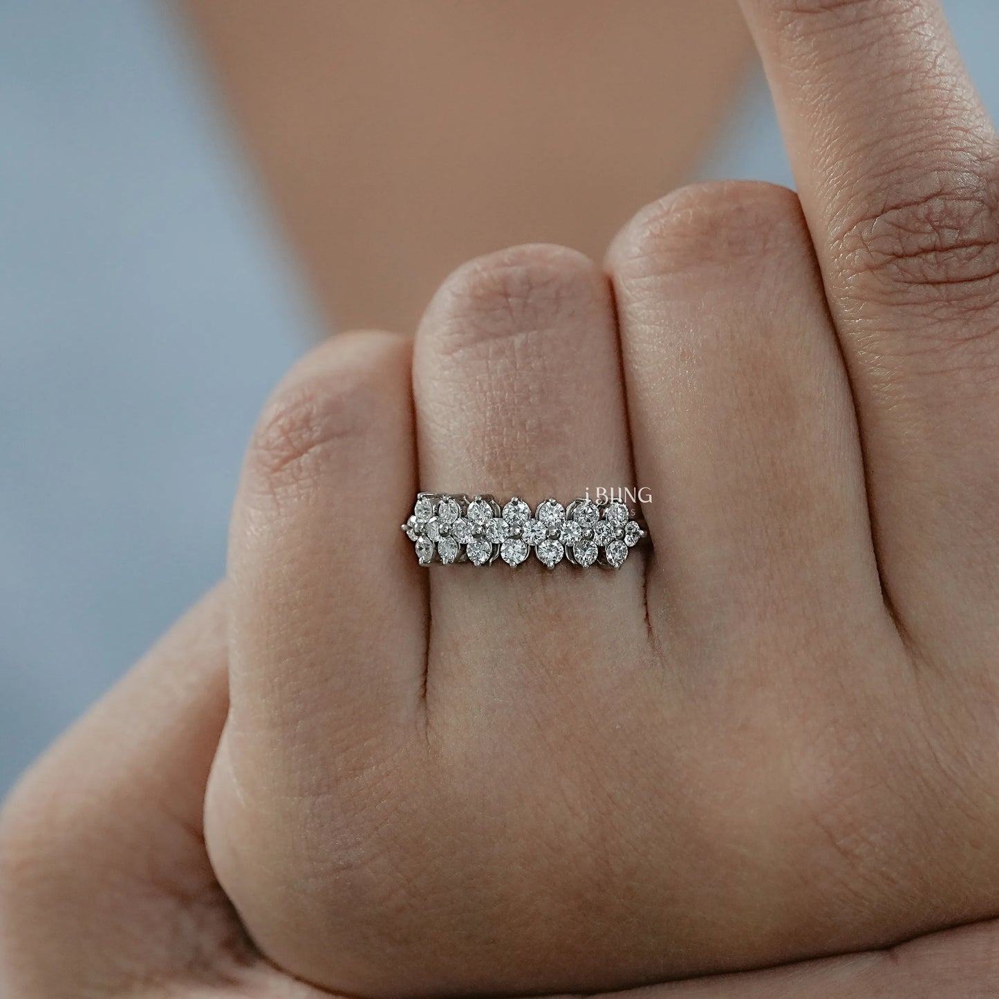 Woman hand Women’s lab grown diamond wedding band styled in cluster design