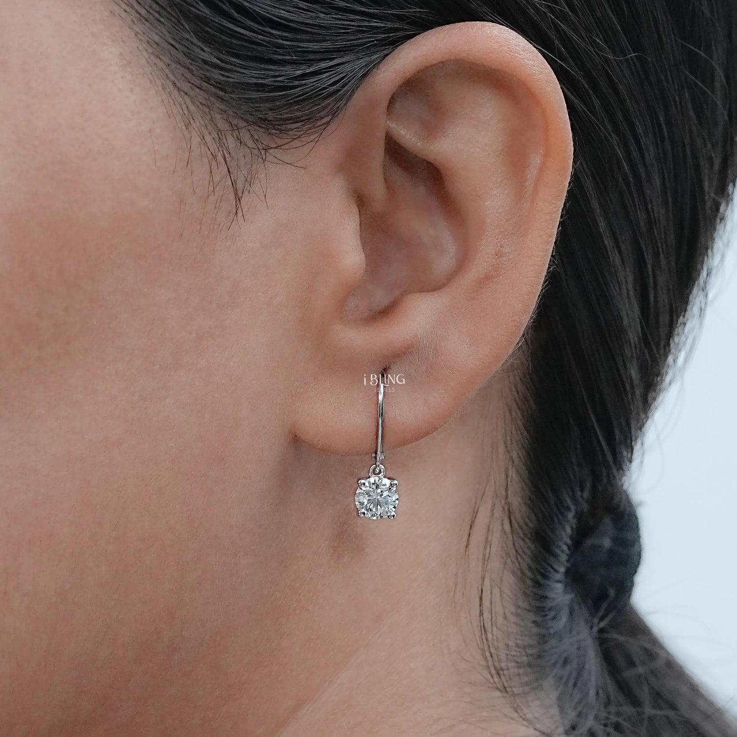 Model wearing gold drop earrings set with lab grown diamonds, luxury jewelry for special events