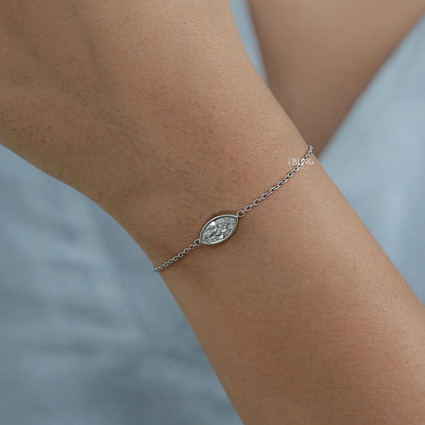 Side view bezel set diamond bracelet featuring marquise cut lab diamond