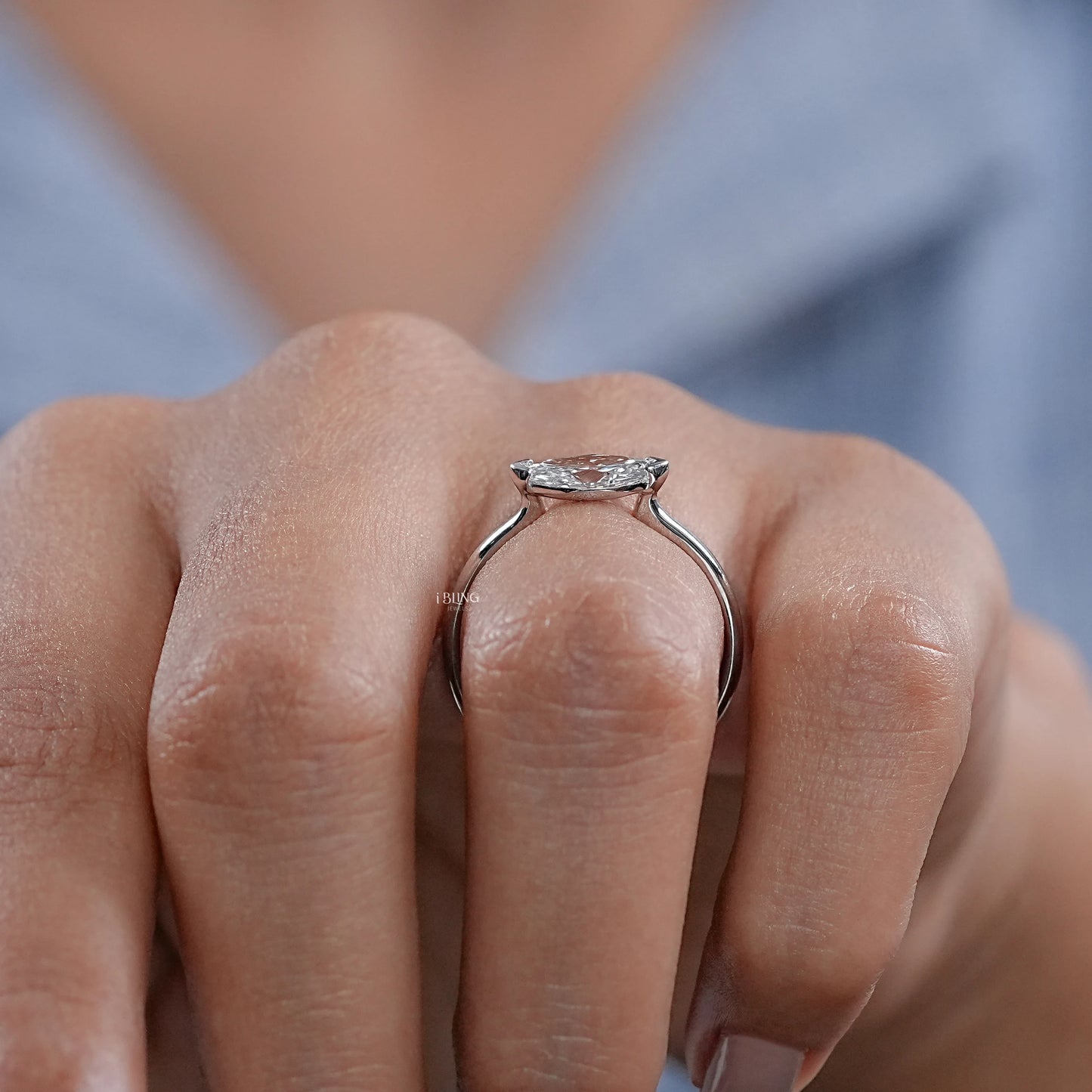 Model hand displays Marquise Diamond Solitaire Ring with East West setting, perfect fashion accessory