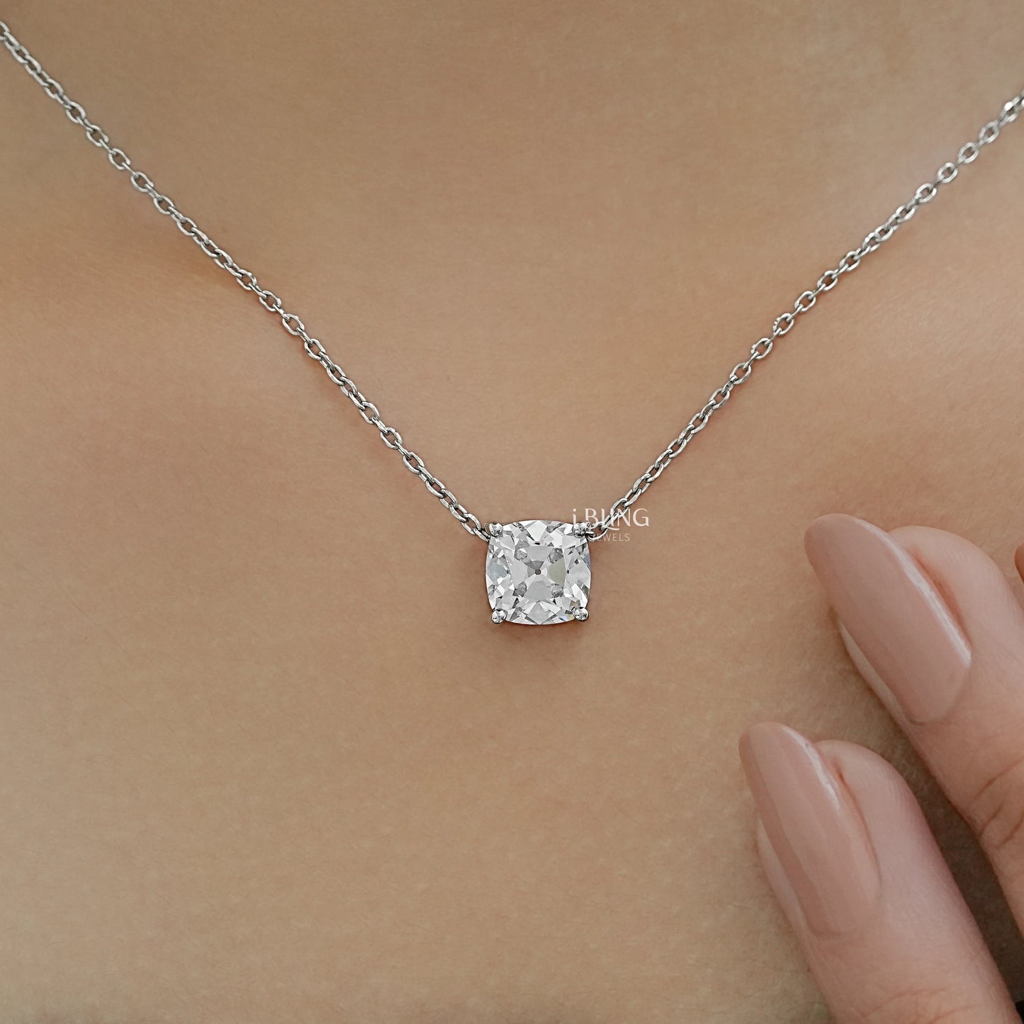 Close-up view of a square diamond solitaire necklace showcasing the secure lobster clasp and link chain.