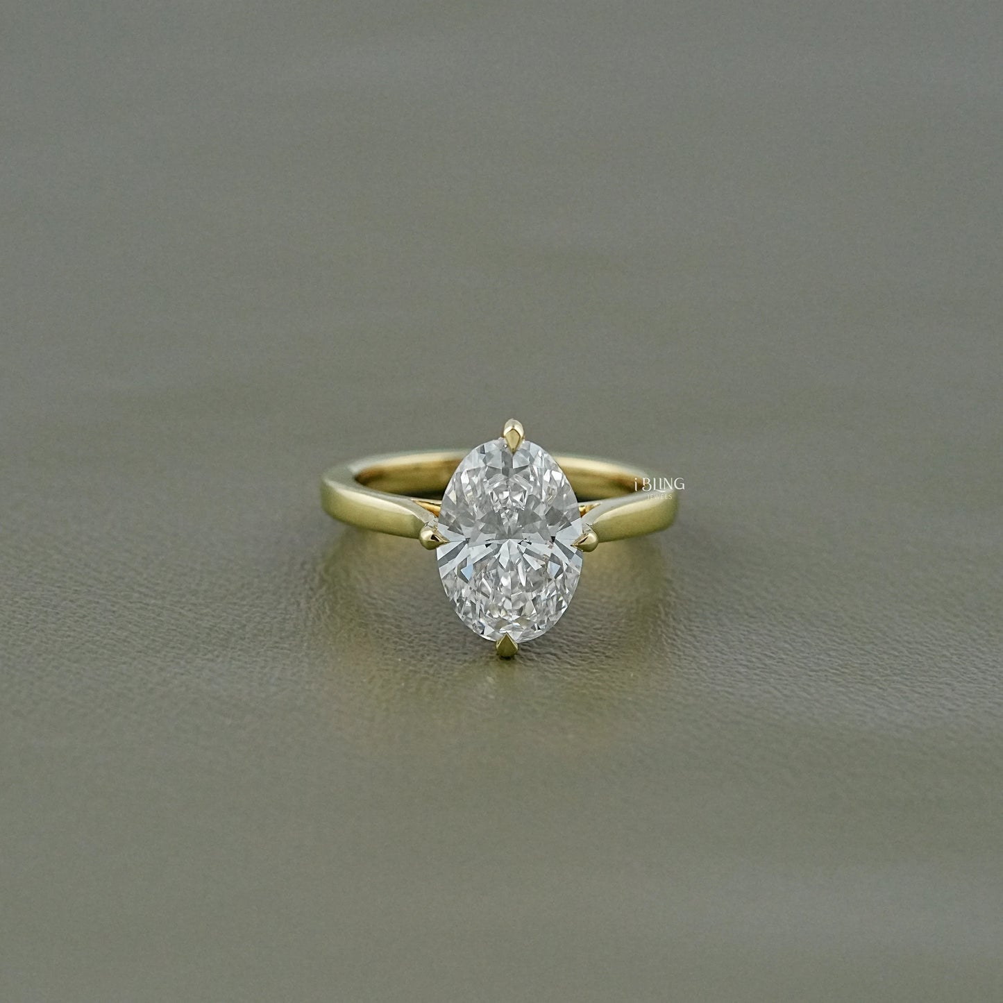 iBling Jewels 3 ct oval lab grown diamond solitaire ring with a high-polished gold band.