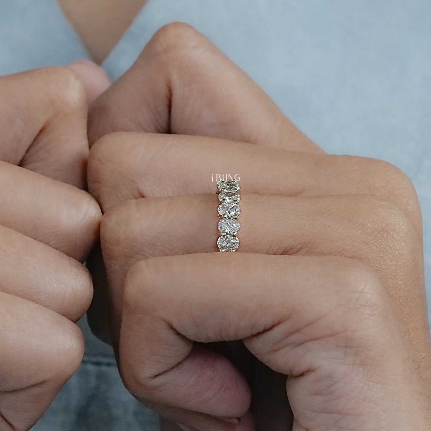 Woman wearing wedding bands for oval engagement rings with diamond setting