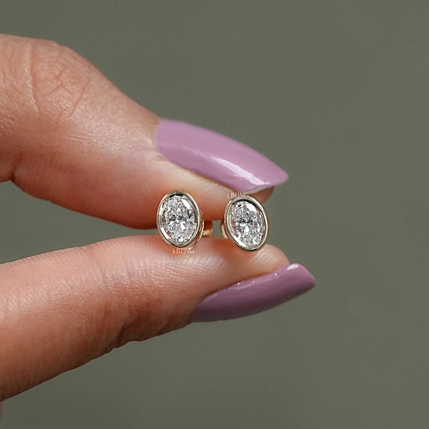 Front view of Bezel Set Oval Cut Lab Grown Diamond Stud Earrings, ideal for engagement or party look