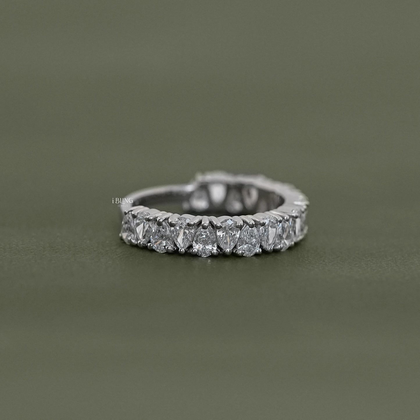 Side view showing Upside Down Pear Cut Diamond Half Eternity Band in gold, perfect bridal ring