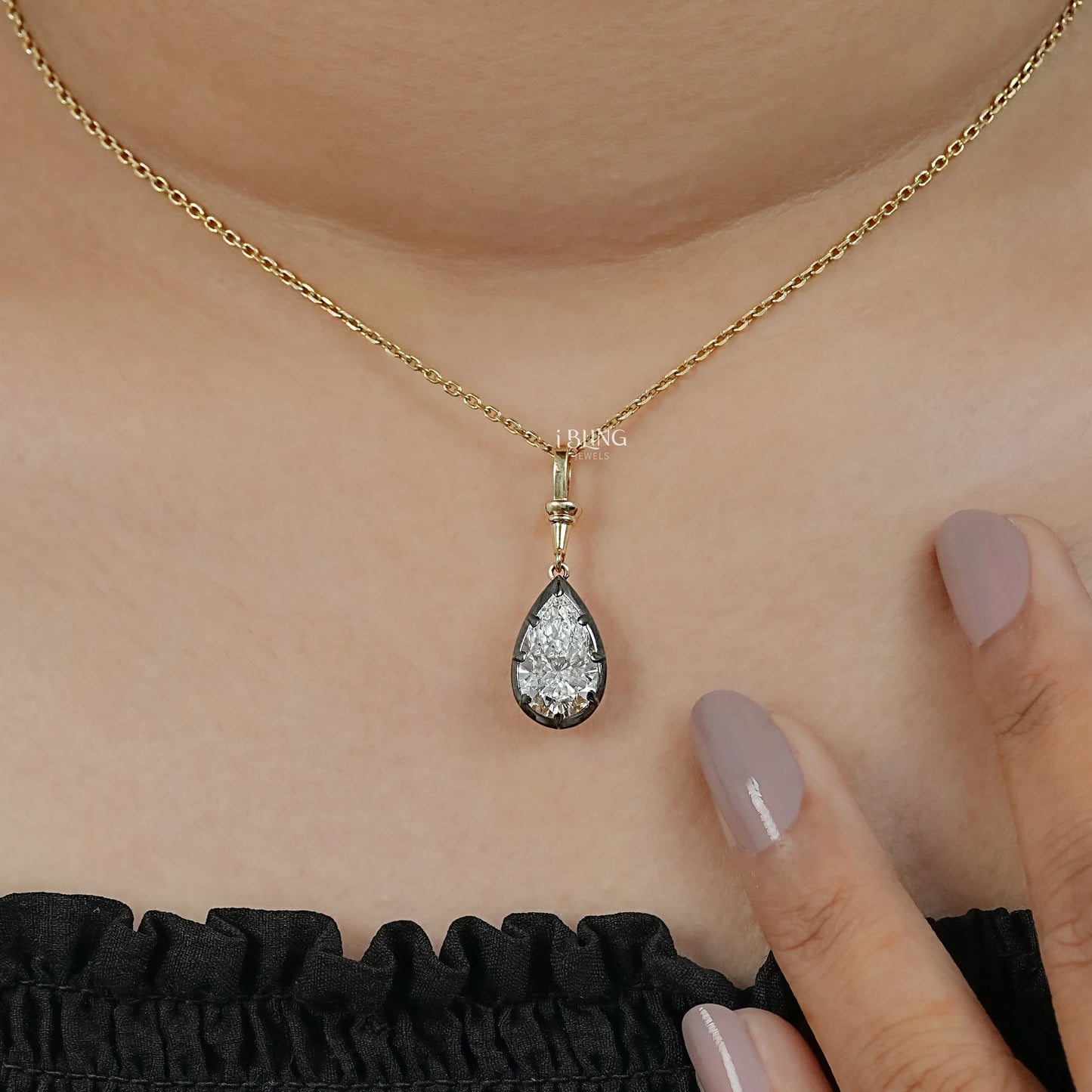 Model neck diamond solitaire pendant necklace styled with pear cut stone