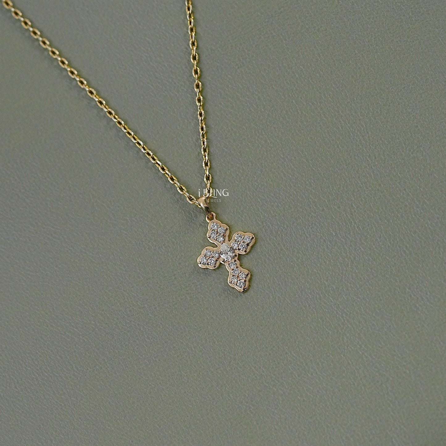 Side view pear cut diamond pendant crafted in cross shape design