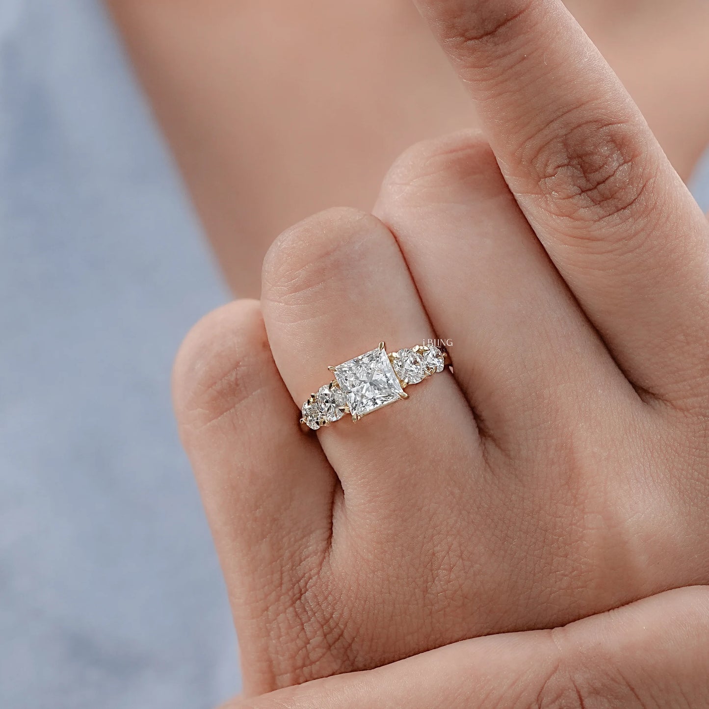Model hand displays Engagement Rings with princess cut diamonds for anniversary