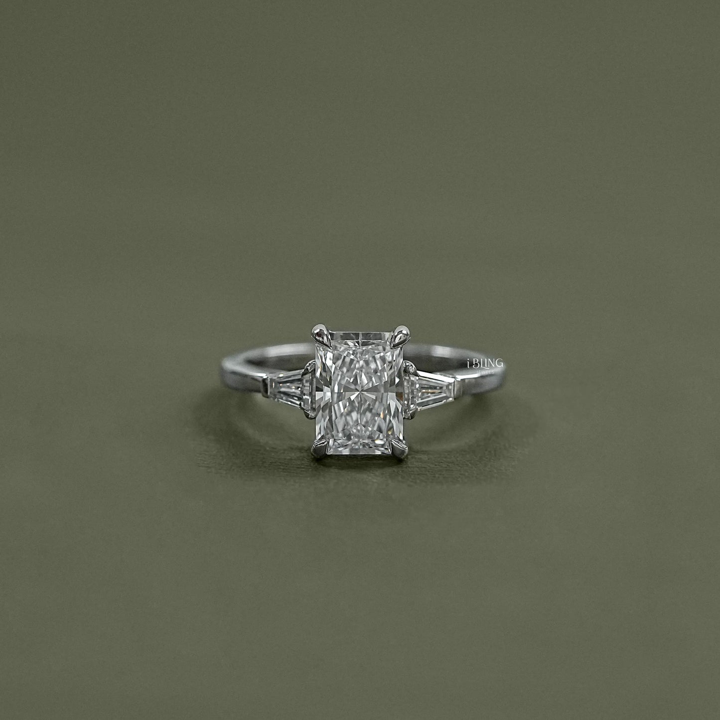 iBling Jewels showcases a Radiant Cut Three Stone Ring crafted with premium lab grown diamond center