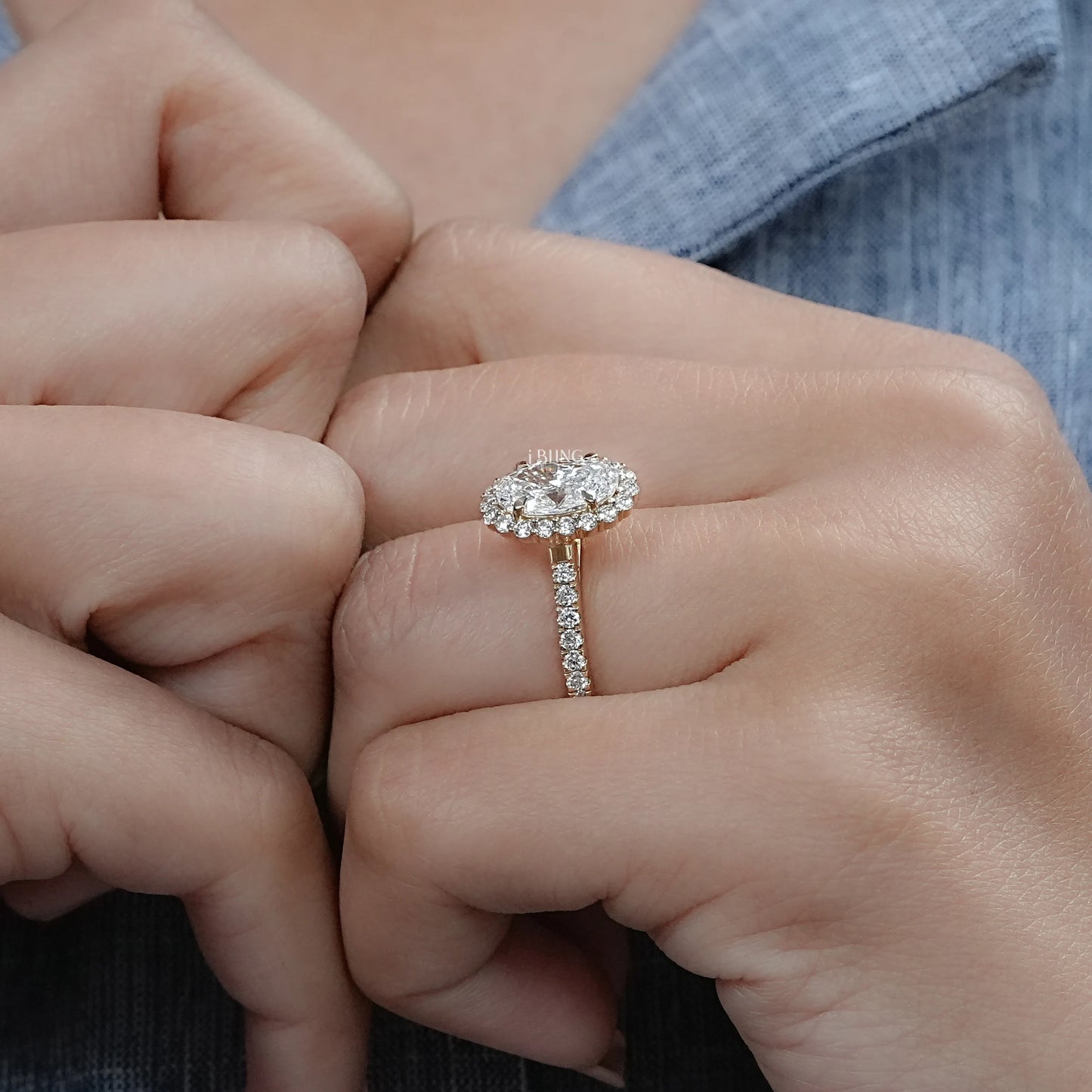 Model hand displays Oval halo lab diamond engagement ring designed for stylish bridal looks