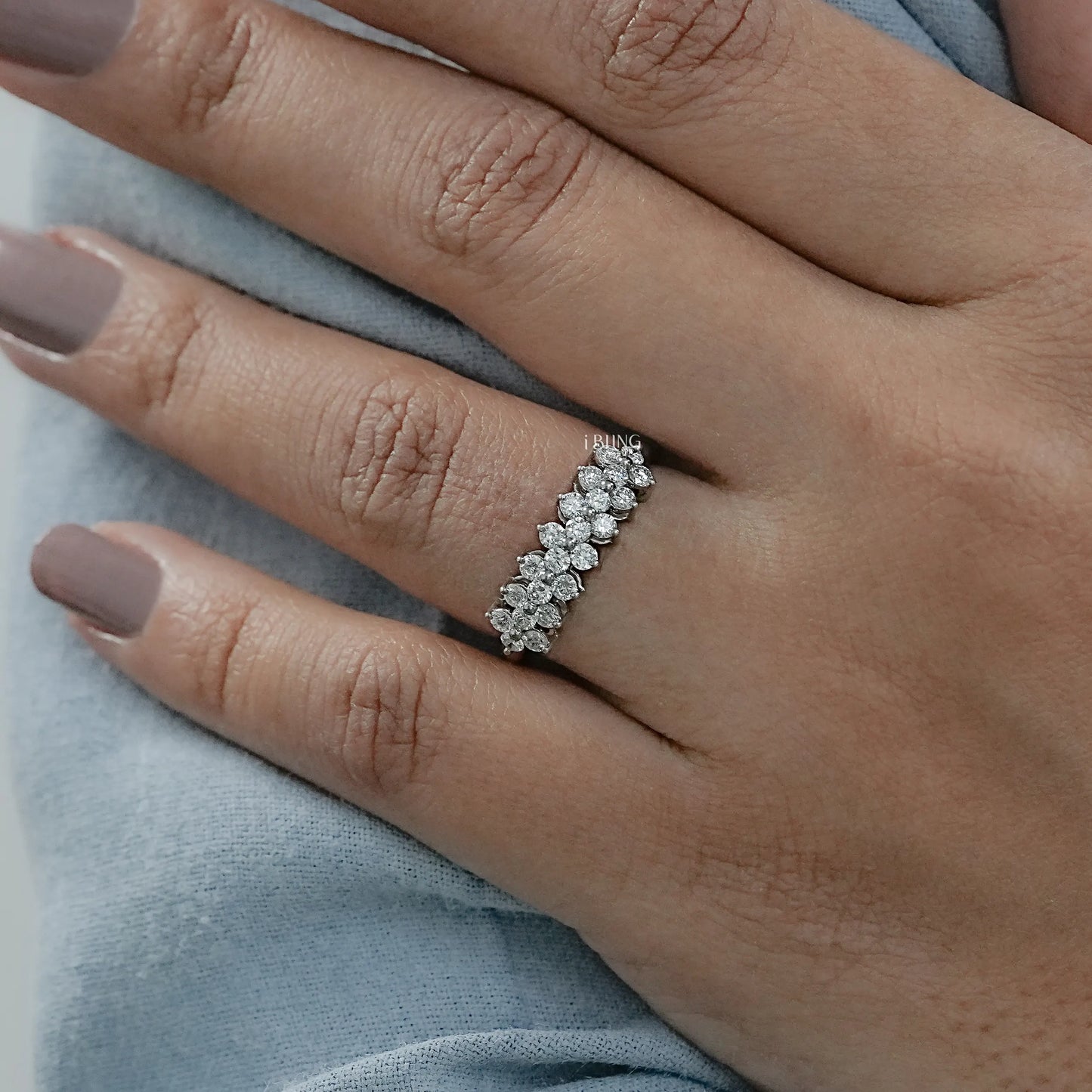 Woman wearing cluster wedding band featuring round lab diamond arrangement