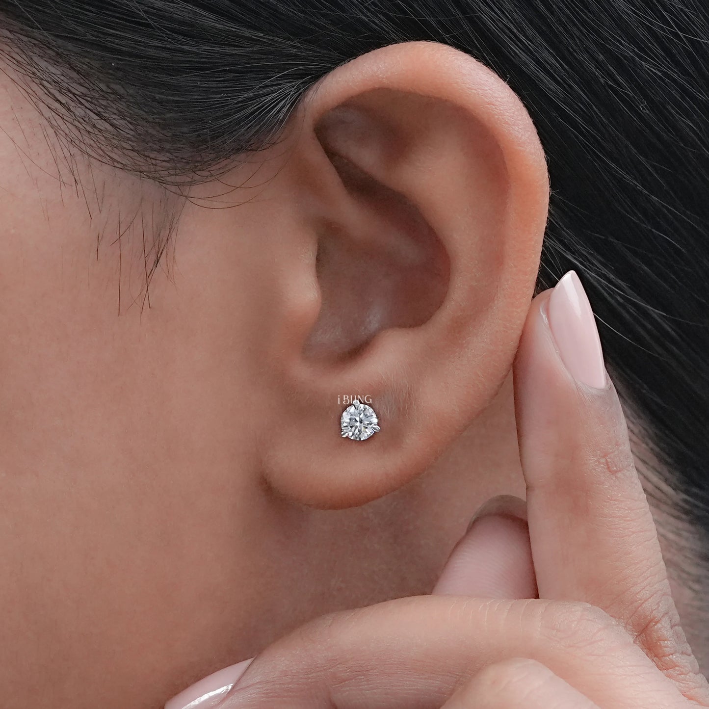 Woman ear wearing Round Diamond Solitaire Stud Earrings with lab-grown stones, modern jewelry style