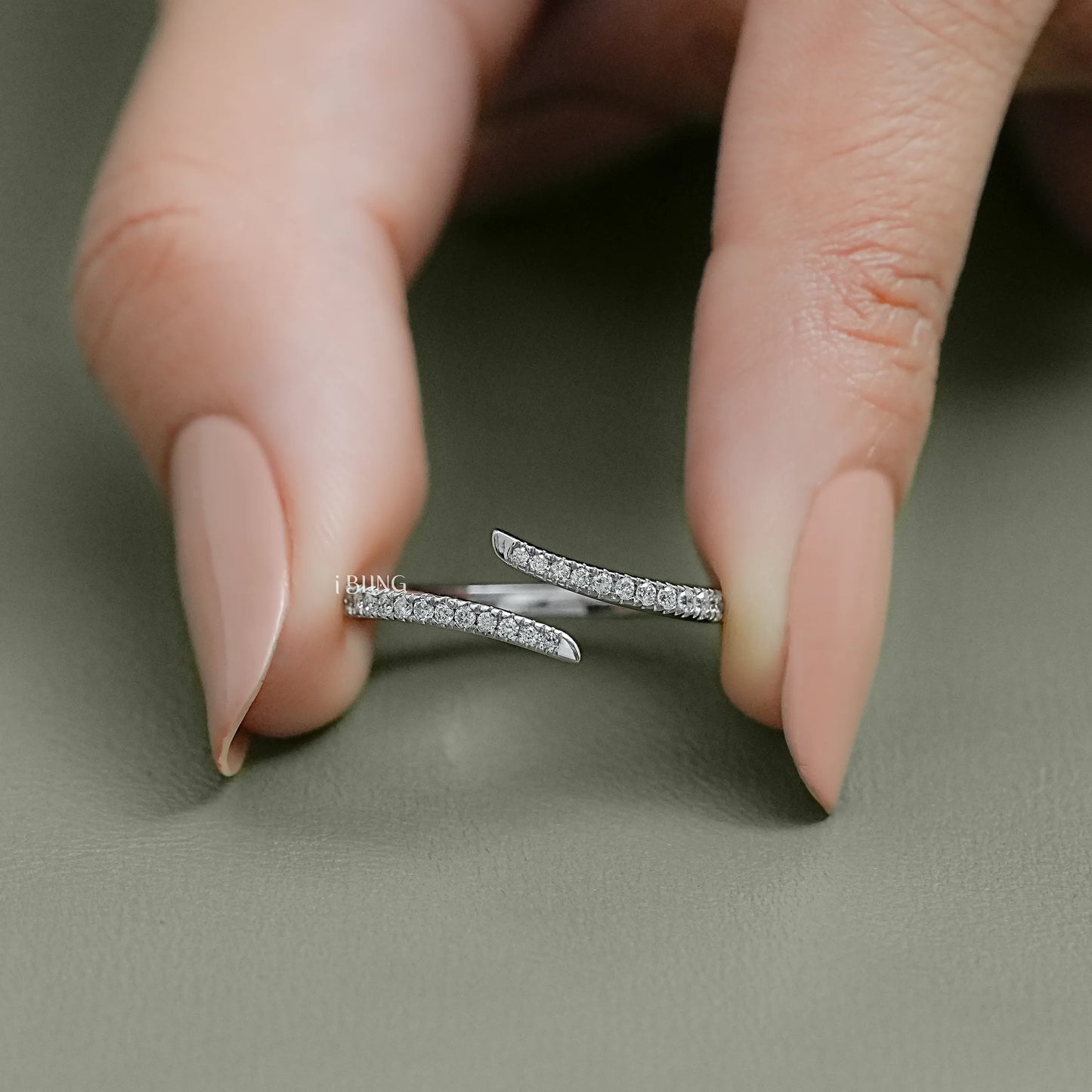 Minimalist 14k gold bypass wedding band featuring round-cut lab diamonds for a high-end fashion aesthetic.