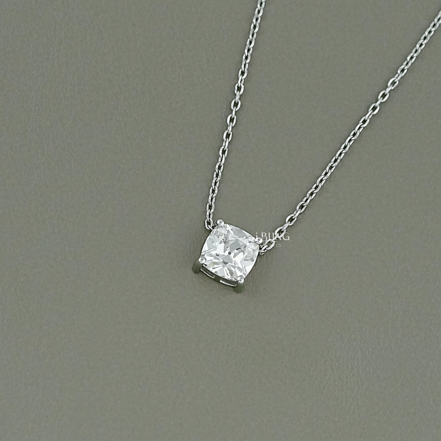 Side profile of a solitaire diamond pendant necklace showcasing the refined basket setting for light return.