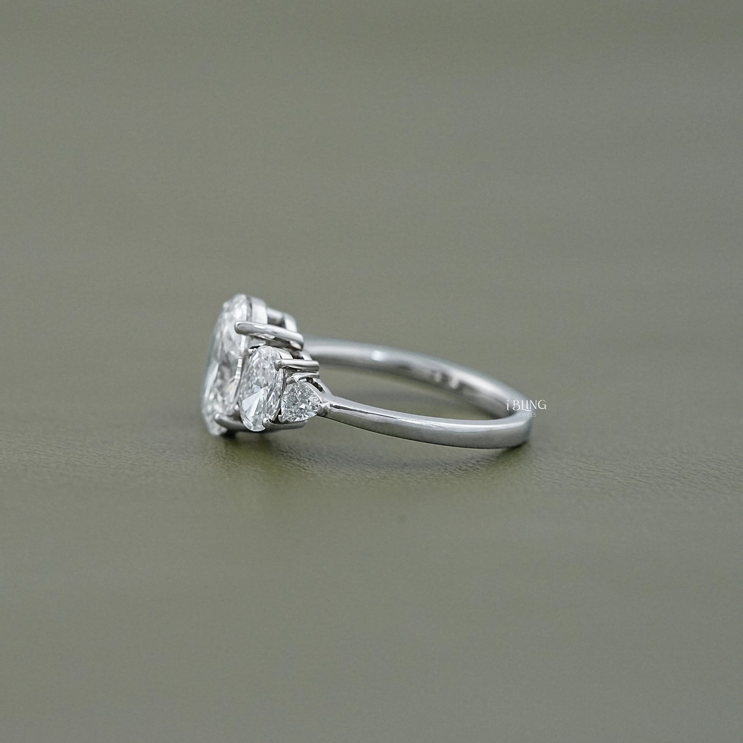 Side view of Five Stone Engagement Ring featuring Oval Lab Grown Diamond with Trillion accent stones